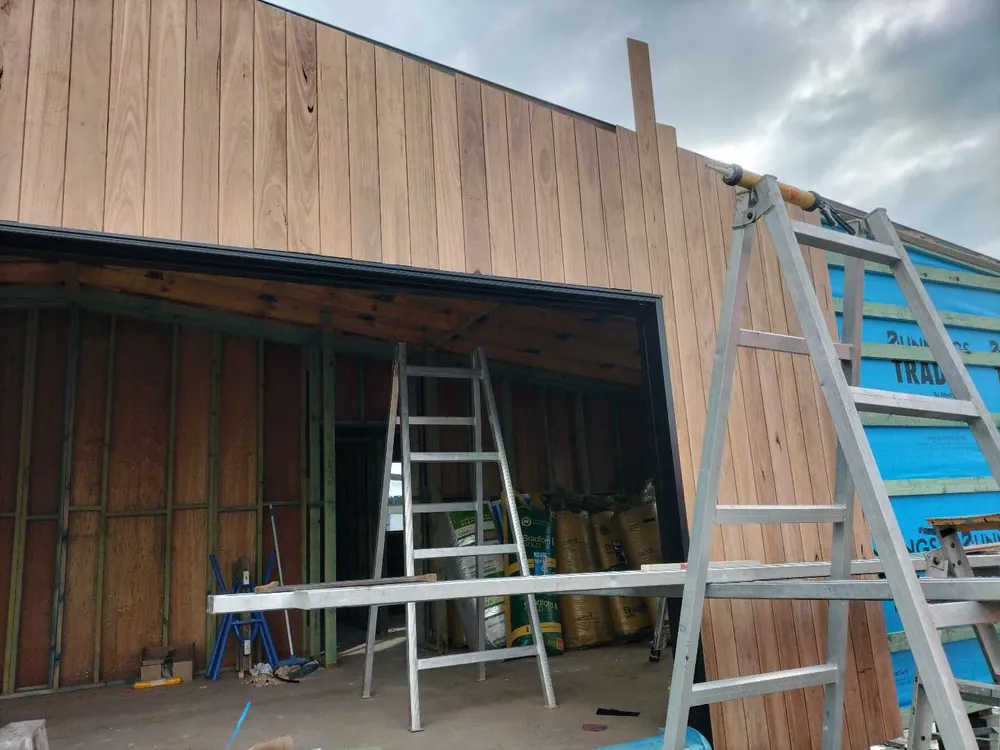 Exterior timber cladding being installed, a Seaforth Builders project on the Gold Coast