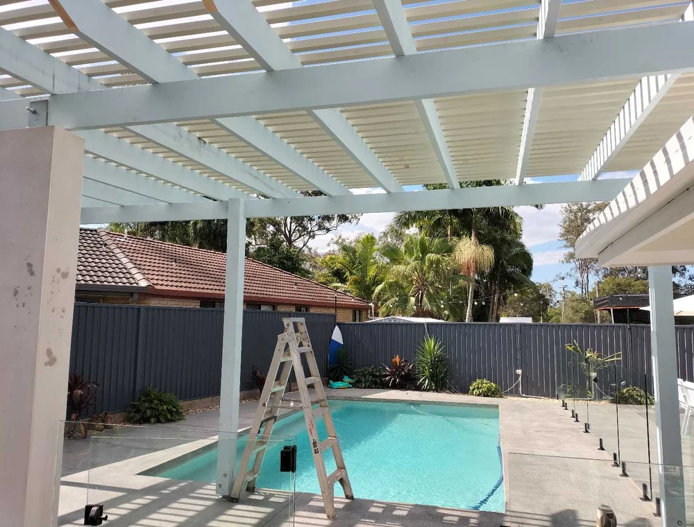 White pergola structure over a backyard pool area, a Seaforth Builders project on the Gold Coast