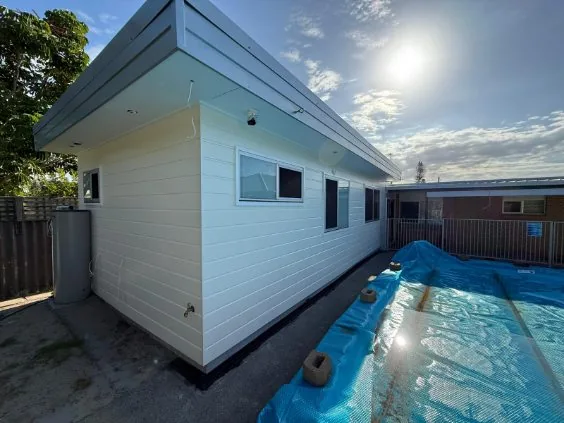 Weatherboard extension beside a new pool, a Seaforth Builders project on the Gold Coast
