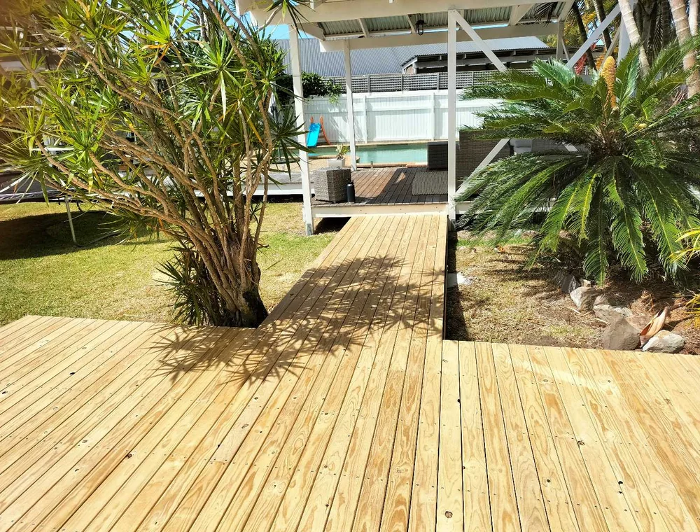 Timber deck built around a landscaped garden bed, a Seaforth Builders project on the Gold Coast